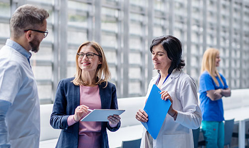 Pharmaceutical sales representative talking to doctors about PathoZoom